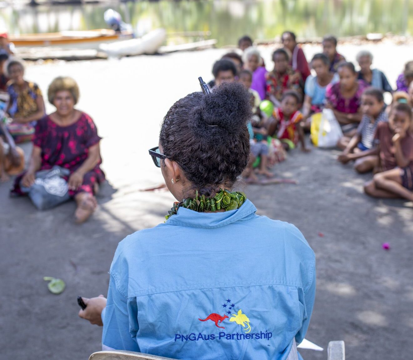 Woman sitting outside speaking to a group of people